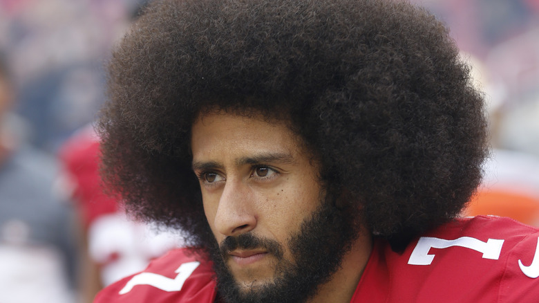 Colin Kaepernick bushy hair looks to the side