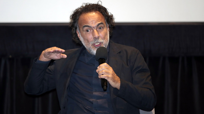Alejandro González Iñárritu speaking on the microphone in 2025