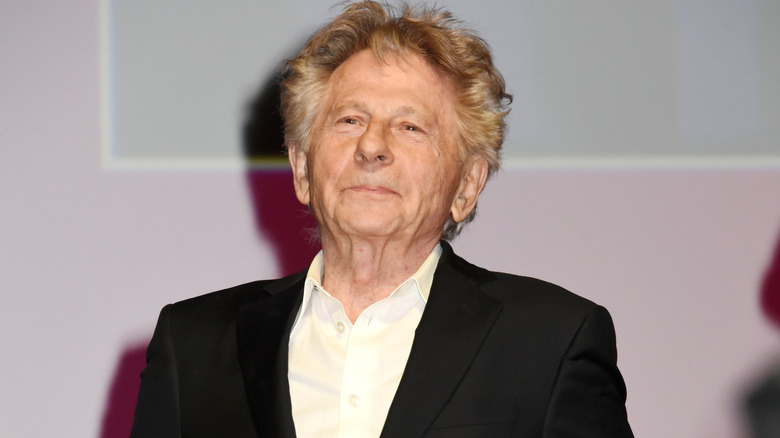 Roman Polanski posing for a photo