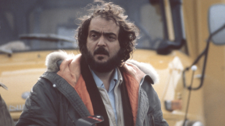Stanley Kubrick looking around on a film set