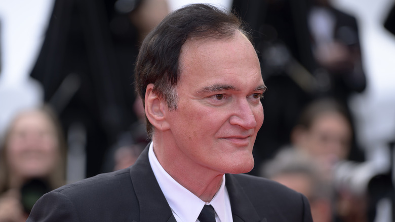 Quentin Tarantino smiling on the red carpet in 2025