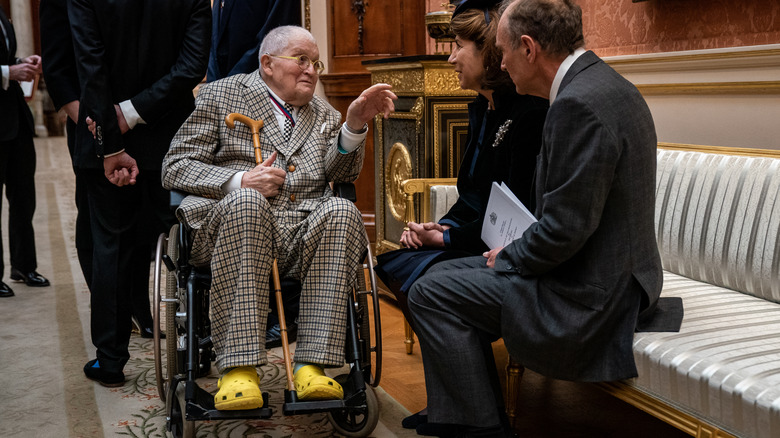 David Hockney wheelchair cane yellow crocs talking