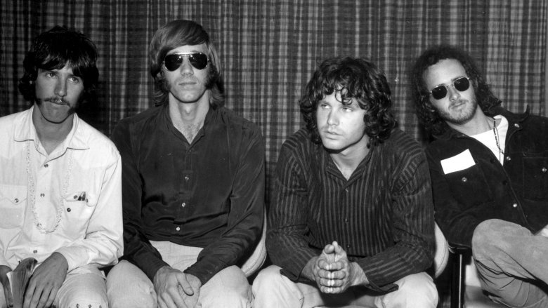 Jim Morrison sat with band members of the Doors