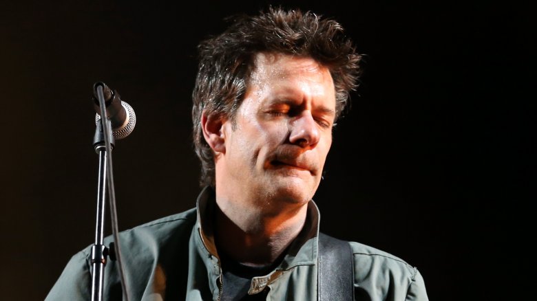 Paul Westerberg eyes closed by mic on stage