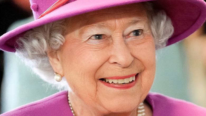 Queen Elizabeth II in pink smiling in 2015