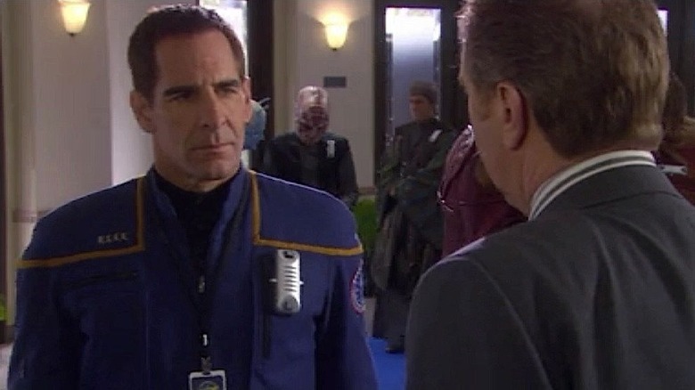 Archer speaks to the president with a universal translator on his chest