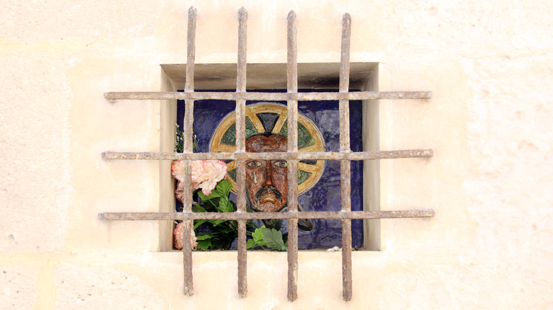 Portrait of Jesus behind bars