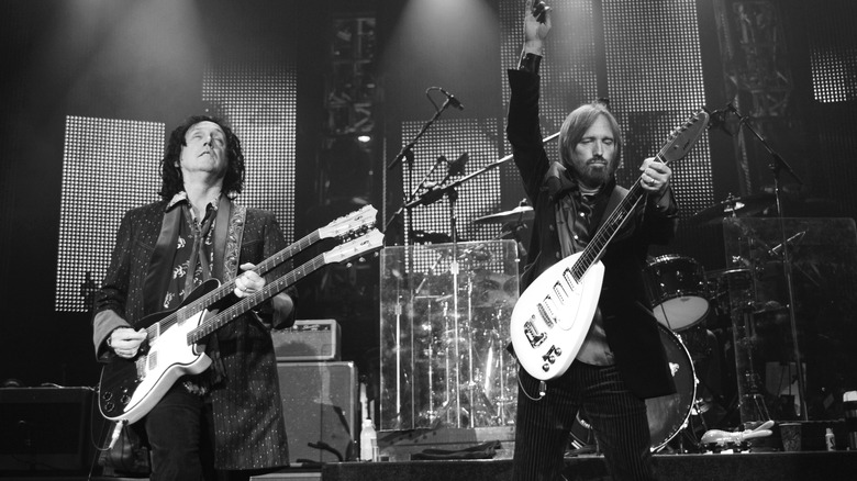 Tom Petty and Mike Campbell of the Heartbreakers performing on stage