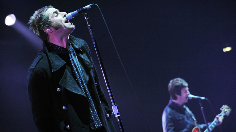 Oasis' Liam and Noel Gallagher performing on stage in 2009