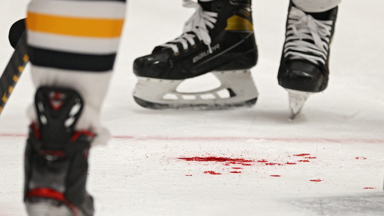 Hockey skates and blood on the ice