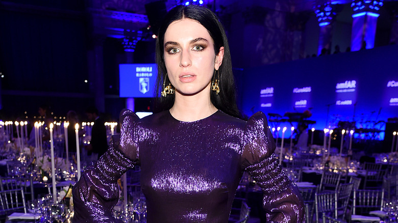 Tali Lennox posing in purple dress
