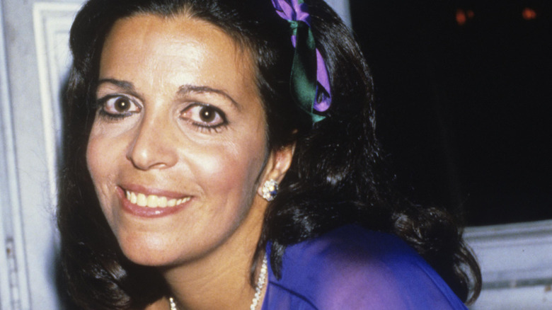 Christina Onassis looks up and smiles