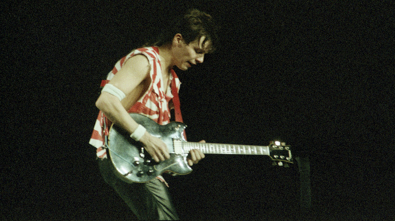 Andy Taylor performs on stage