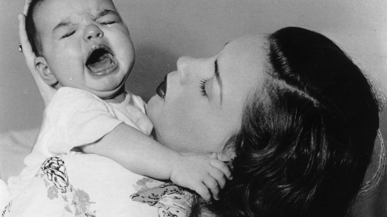 Judy Garland holding a crying Liza Minnelli 