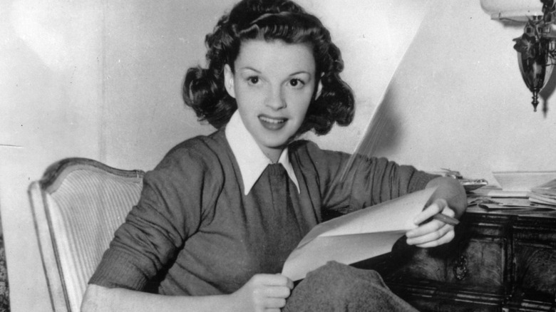 Judy Garland seated and posing