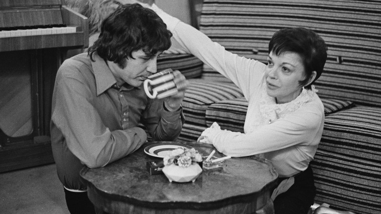 Mickey Deans and Judy Garland, seated and talking