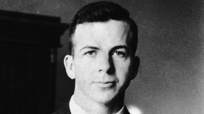 Lee Harvey Oswald staring ahead suit