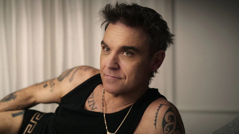 Robbie Williams talks to documentarians in bed