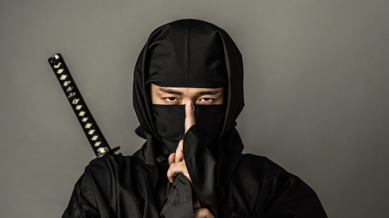 ninja with sword holding finger up
