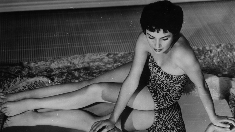 Susan Cabot laying on rug