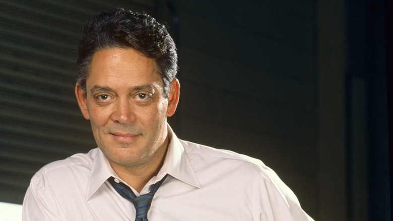Raul Julia smirking