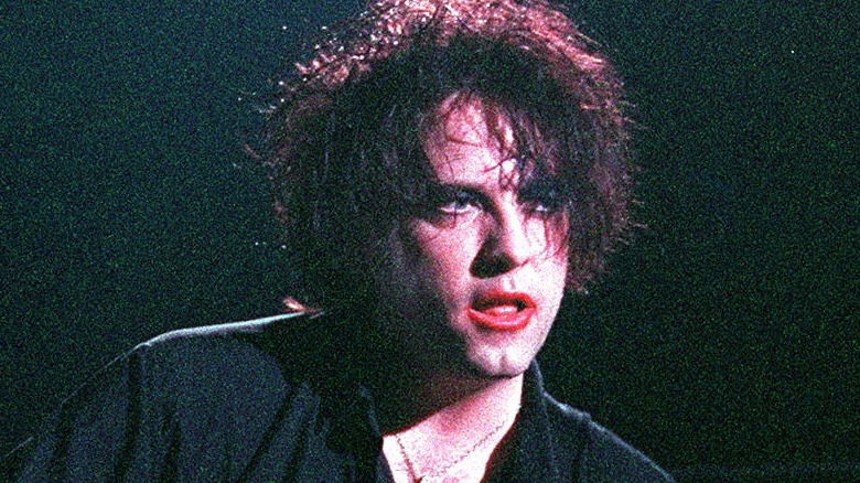 Robert Smith playing with The Cure 1980s