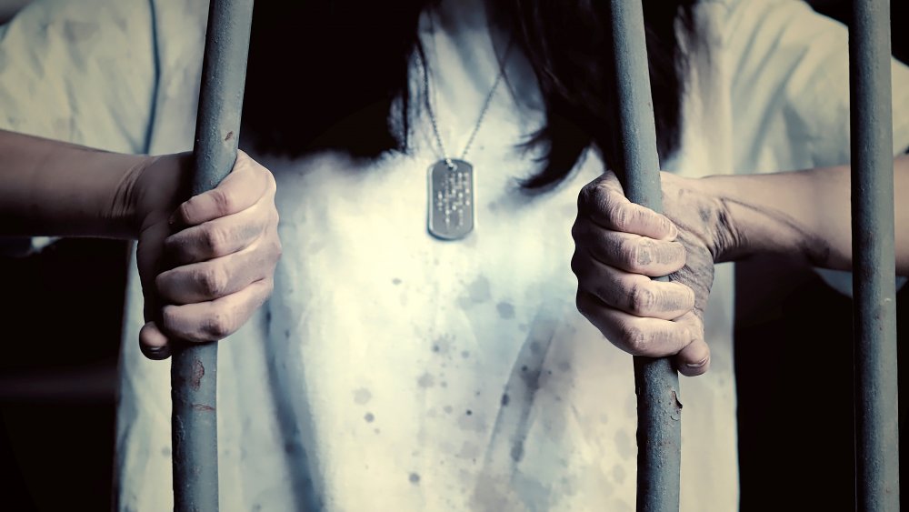 Woman trying to escape from a prison.
