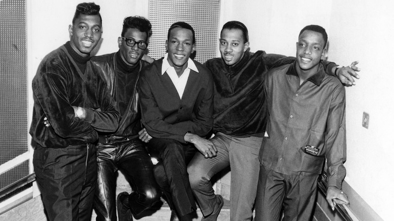 The Temptations together smiling
