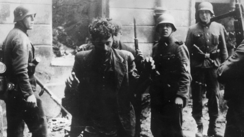 Captured Jewish fighter raising hands