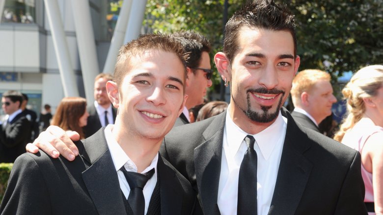 Jake and Josh Harris standing smiling suits at event