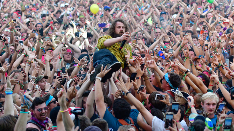 a performer crowd-surfing at bonnaroo