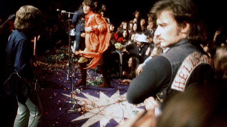 Keith Richards, Mick Jagger, Hells Angel onstage