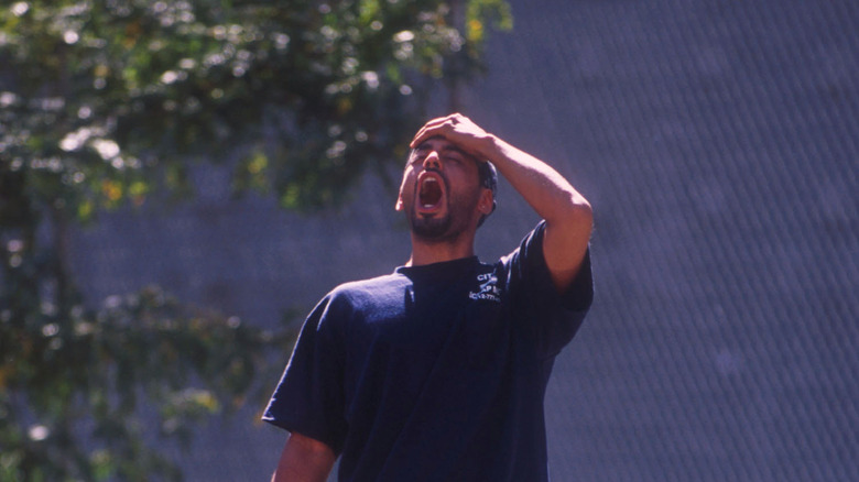 Man in anguish with hand on forehead