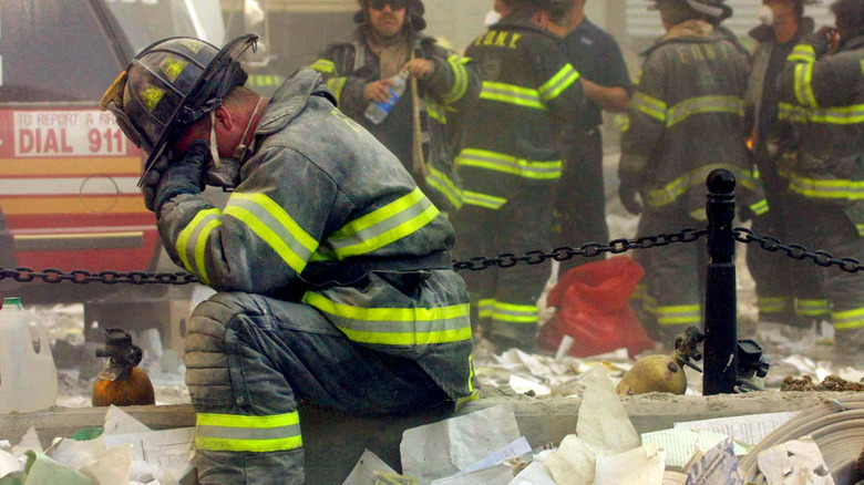 Firefighter kneeling in 9/11 rubble
