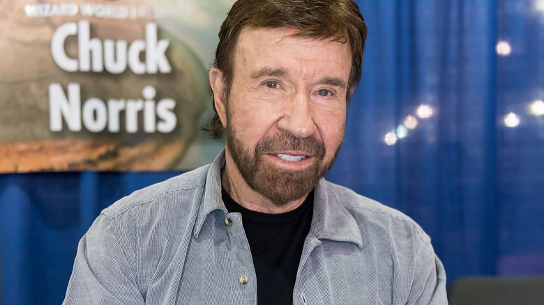 Chuck Norris in front of a poster