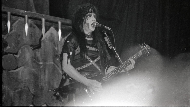 Mick Mars playing guitar and singing