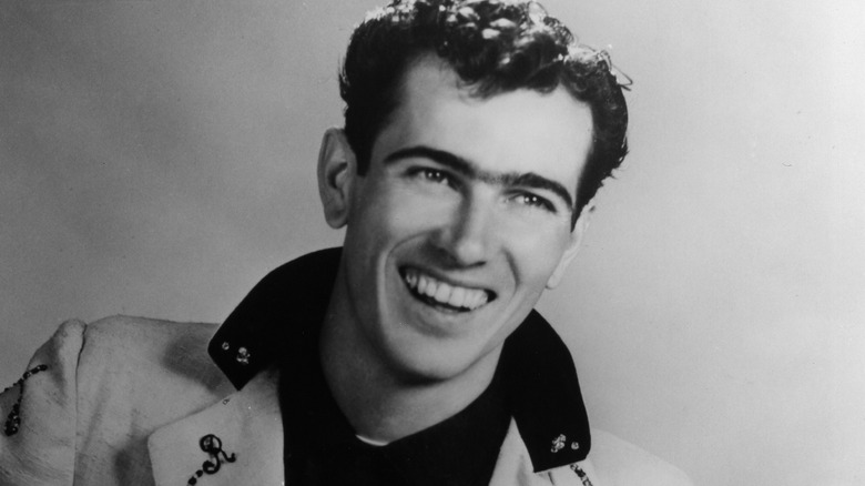 Ray Smith suit popped collar smiling