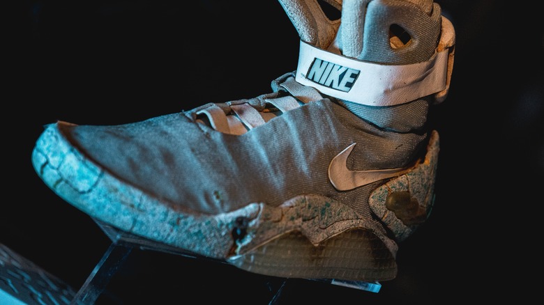 Worn Nike Air Mag rests on a footstand
