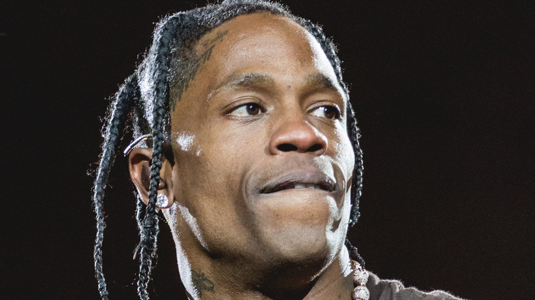Travis Scott singing into a microphone, 2021