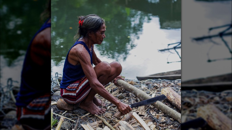 A woman who left the Togutil chopping wood