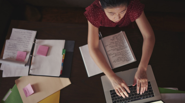 Woman diligently working at lap top