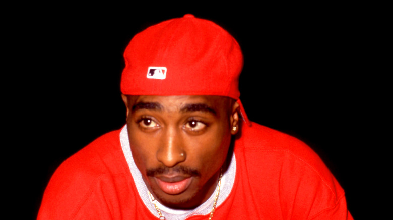 Rapper Tupac Shakur red hat shirt