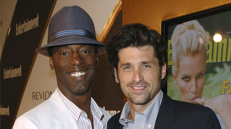 Isaiah Washington in hat smiling with Patrick Dempsey smiling
