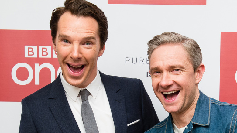 Benedict Cumberbatch and Martin Freeman laughing and pointing