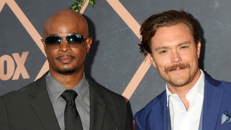 Damon Wayans not smiling by smiling Clayne Crawford at Fox event