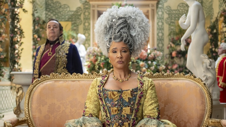 Queen Charlotte sitting on a couch in a scene from Bridgerton