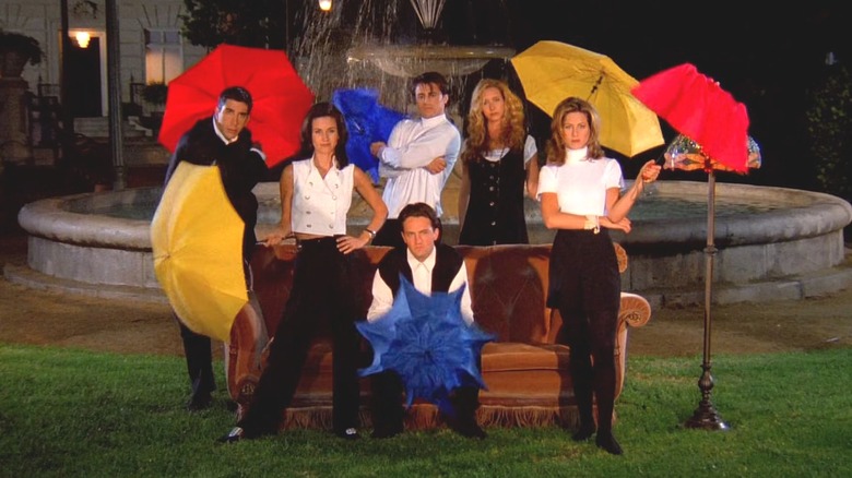 cast of Friends holding umbrellas