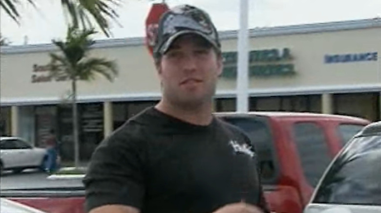 Jeff George in hat gets out of car