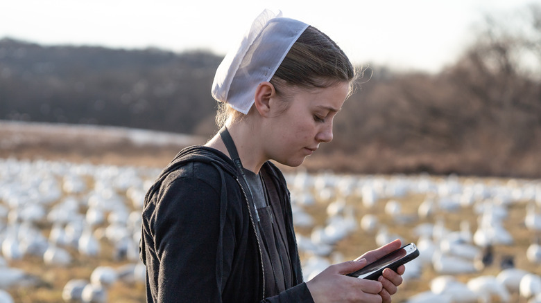 amish woman looking at phone