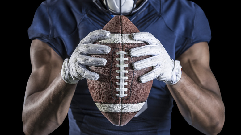 Football player holding football